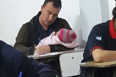 La tierna imagen del bombero que rindió un examen con su beba en brazos